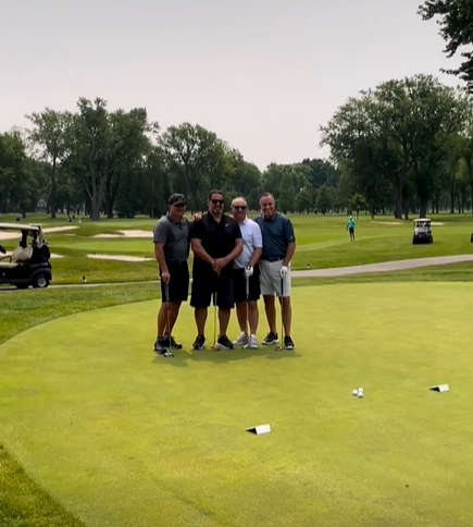 4 people on a golf course